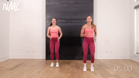 two women marching in place as part of an indoor walking workout