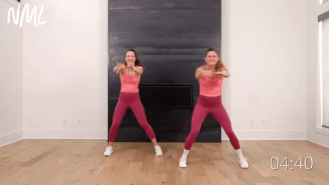 two women performing a side to side step touch in a walking workout