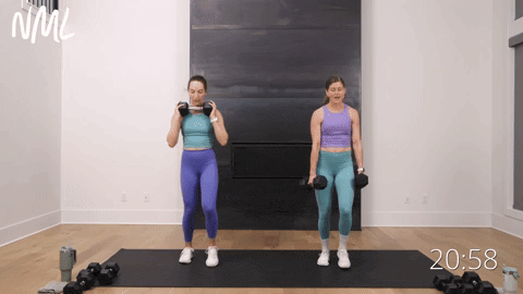 two women performing pendulum lunges with dumbbells in a full body workout routine