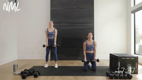 woman performing kneeling y flys and woman performing y flys with dumbbells from standing