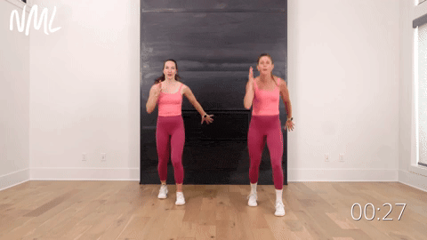 two women performing split stance runners as part of an indoor walking workout to get your steps in
