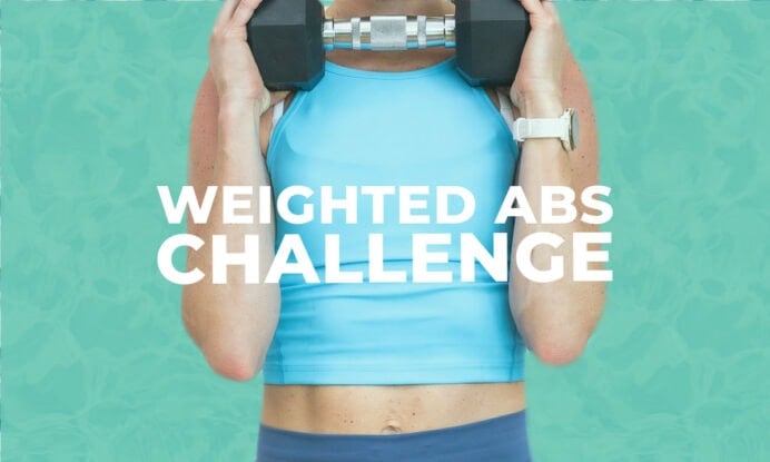 woman holding dumbbell at chest