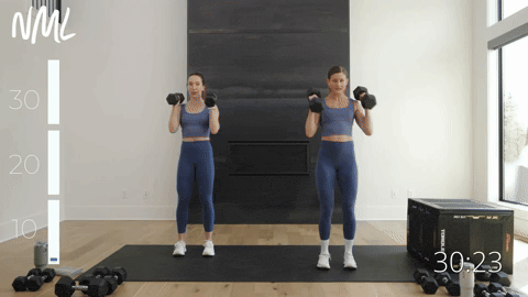 two women performing a dumbbell back row and clean in a back and shoulder workout