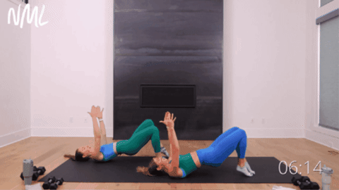 two women performing releve glute bridge marches as example of barre pilates exercise