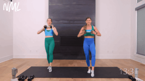 two women performing a standing ab sequence