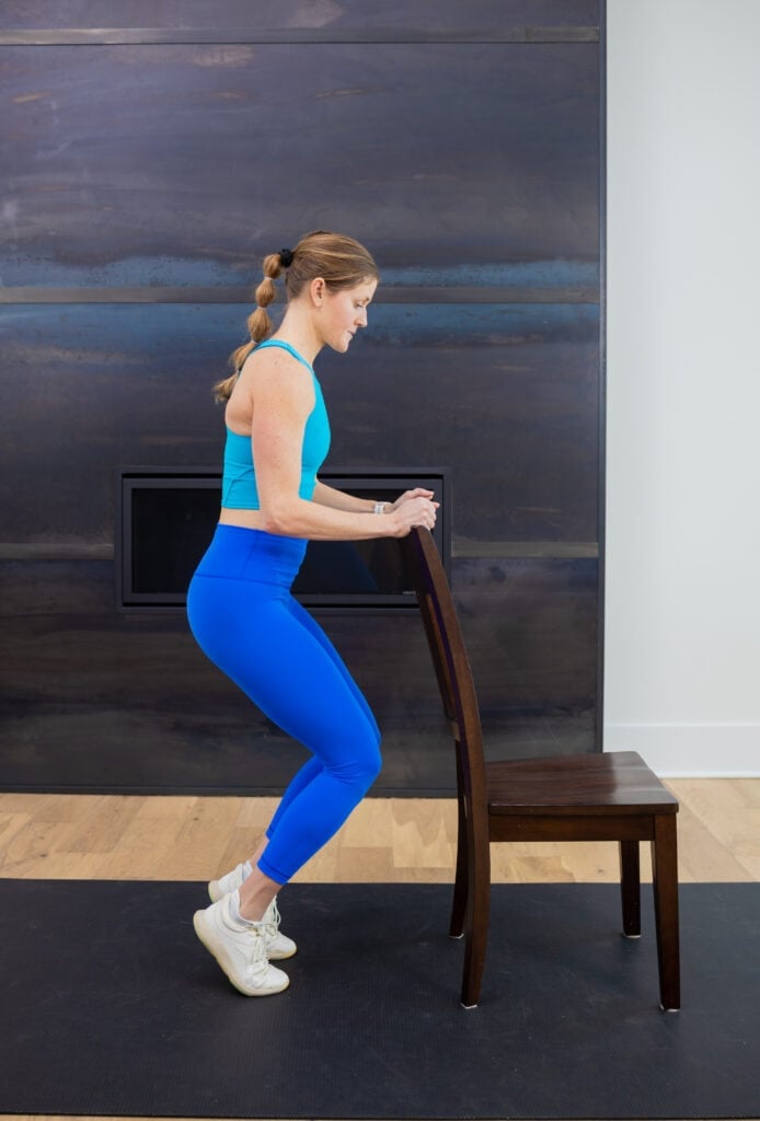 woman performing knee extensions as part of knee strengthening workout.