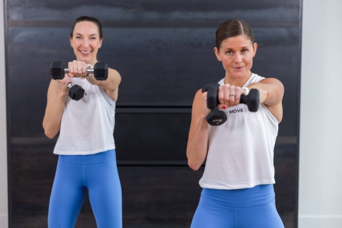 two women performing a crossbody punch as part of boxing workout at home