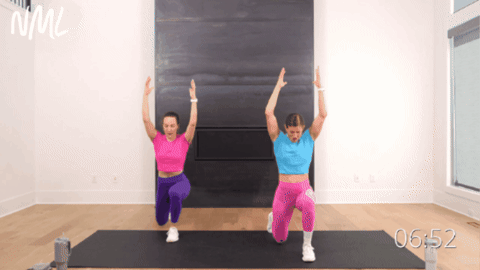 standing women performing a lunge with a knee drive