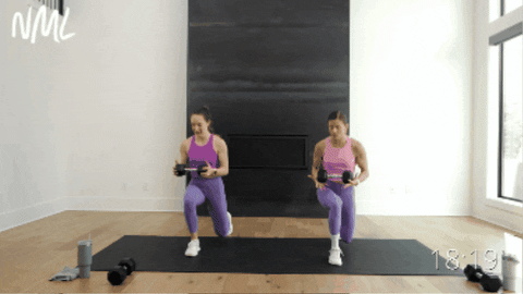 two women performing a reverse lunge with a torso rotation as part of core circuit workout