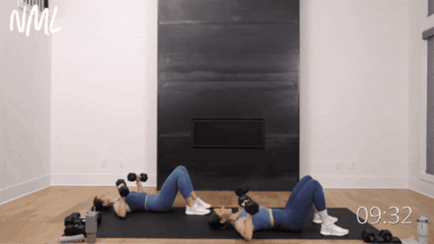 two women performing dumbbell chest presses as part of full body and arm workout routine