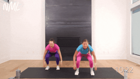 two women performing a squat with a calf raise as part of beginner hiit workout