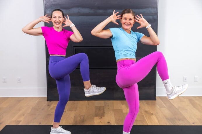 two women performing a standing crunch