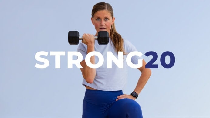 Woman holding dumbbell near face as part of functional strength program