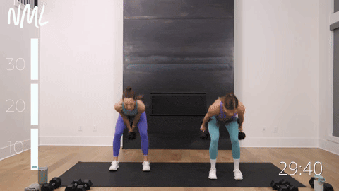 two women performing suitcase swings in a full body workout