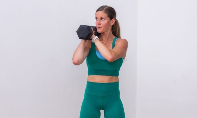 woman holding one dumbbell as part of unilateral training workout